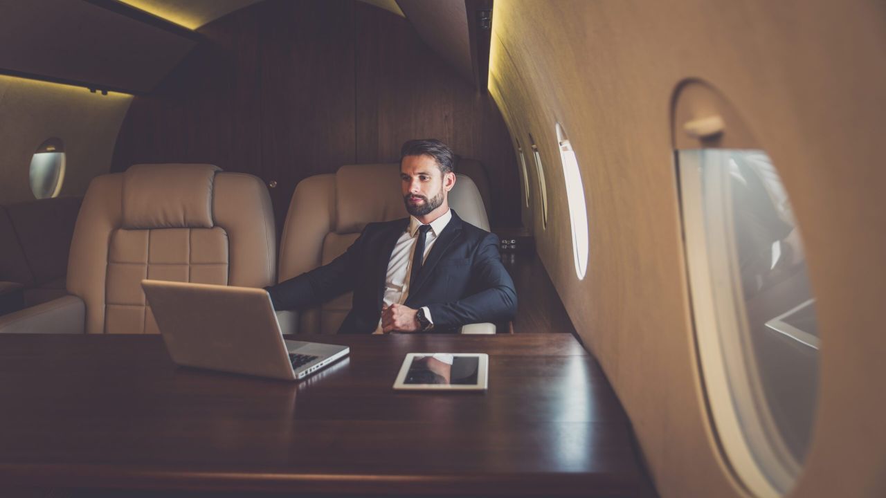 Businessman flying on his private jet